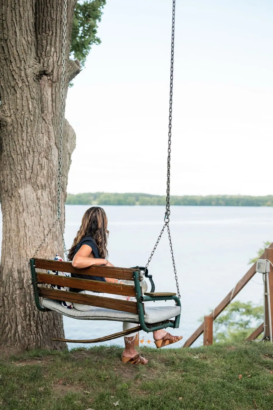 Holly on the bench swing, looking out over the lake