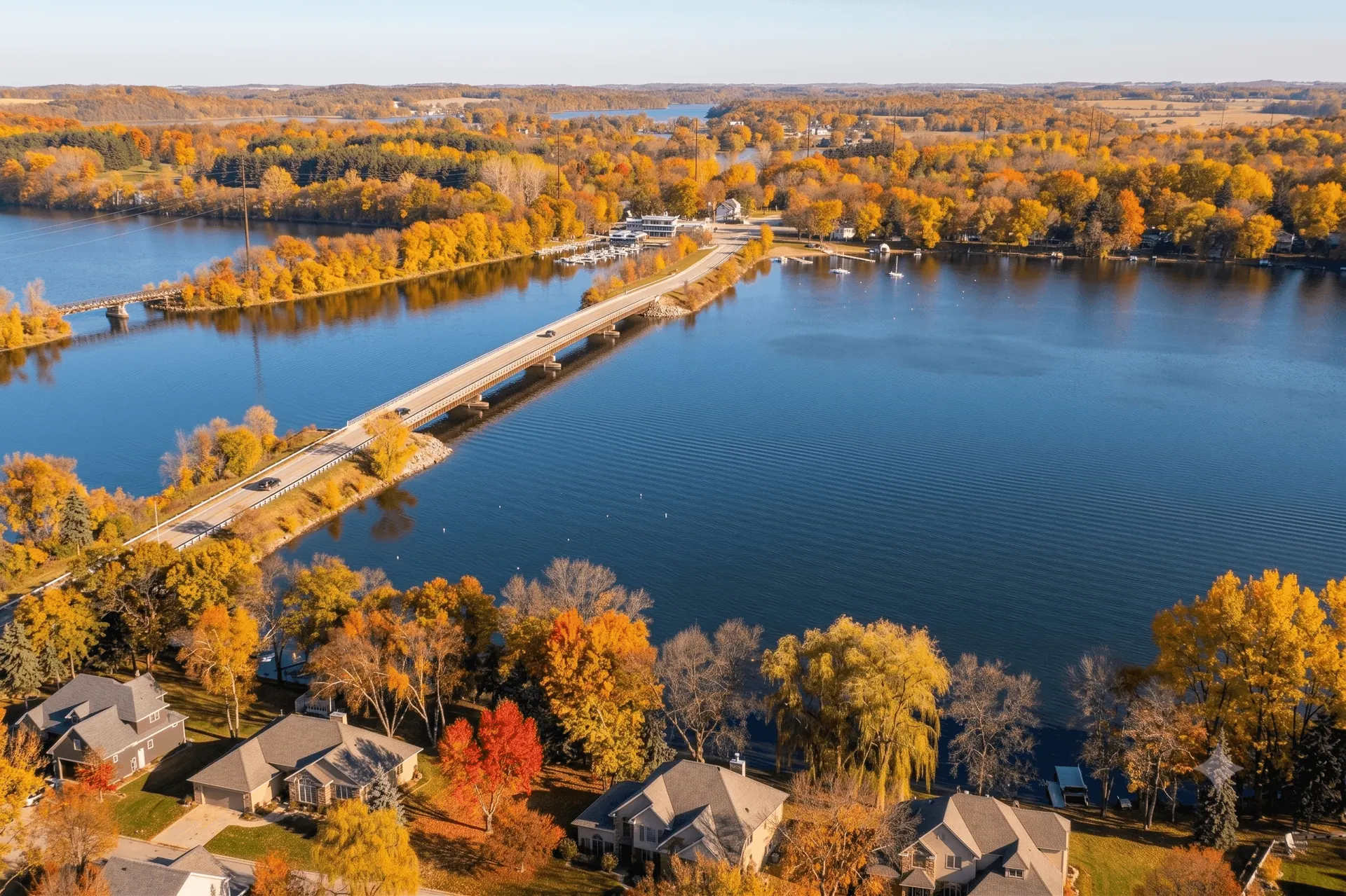 Fall color surrounding the Lake Wissota bridge and shoreline homes